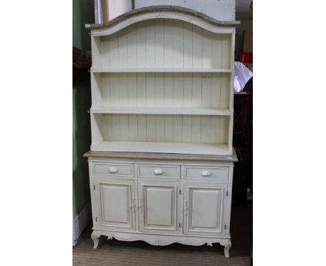 A DECORATIVELY PAINTED TWO PART DRESSER STYLE UNIT with triple shelf plate rack back, the base unit having three inline drawe