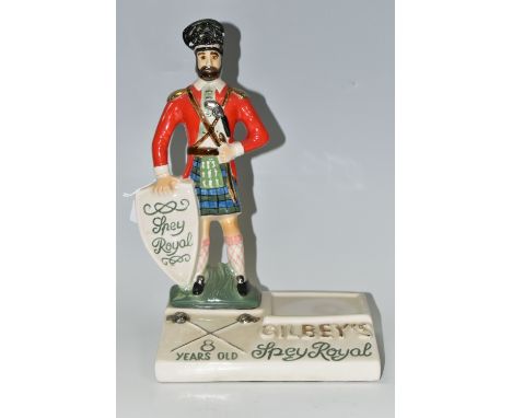 BREWERIANA: A GILBEY'S SPEY ROYAL WHISKY CERAMIC ADVERTISING STAND, a Staffordshire style Highland regimental figure bottle s