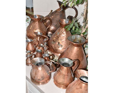 SIXTEEN COPPER JUGS, stamped with measurements, from 1/2 Gill to 5 Gallons, and weights and measures verification marks, 1/2 