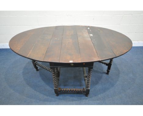 A GEORGIAN OAK OVAL BOBBIN TURNED GATE LEG TABLE, with a single drawer to each end, open width 182cm x closed width 65cm x de