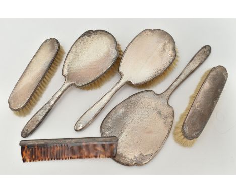 A SIX PIECE SILVER DRESSING TABLE SET, comprising of two hair brushes, a comb, two clothes brushes and a hand held mirror, ea