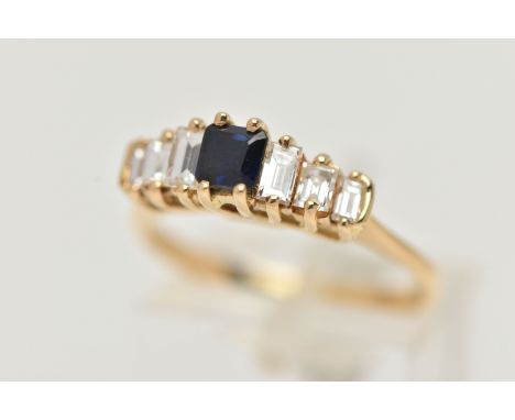 A DIAMOND AND SAPPHIRE DRESS RING, a principally set cushion cut sapphire, flanked with six baguette cut diamonds, prong set 