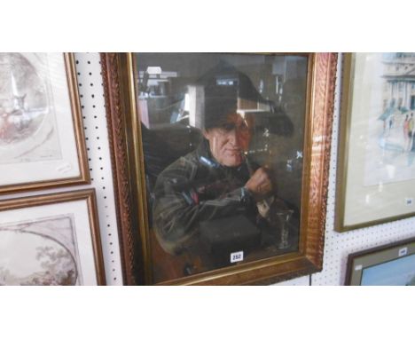 A GILT FRAMED AND GLAZED PRINT OF A MAN SMOKING A PIPE