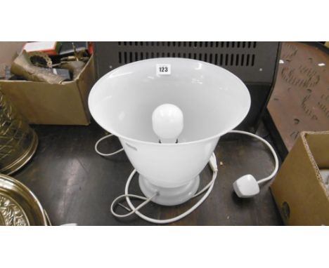 A WHITE VASE CONVERTED INTO A LAMP