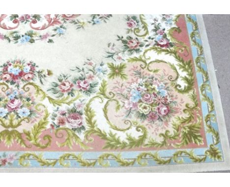 A large floral and foliate decorated carpet with central medallion on light yellow ground within similar border, 360 x 280cm.