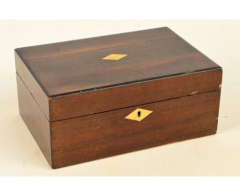 A 19th century walnut sewing box with mother of pearl detailed edge of the hinged lid centred with a vacant shield shaped car