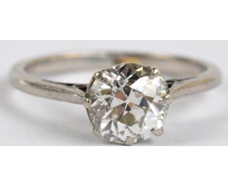 A platinum and diamond solitaire ring, the brilliant cut stone weighing approximately 1.37cts in pierced scrolling mount, cla