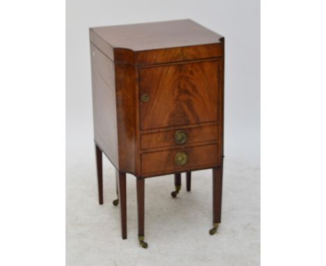 A Georgian mahogany night cupboard/wash stand/commode with shaped front, hinged lid enclosing an aperture for a wash bowl, a 