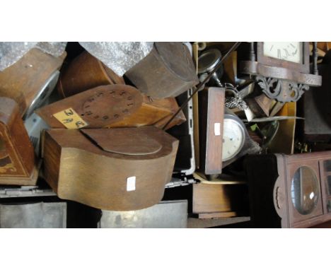 A large quantity of clock parts in various states of disrepair, entirely for restoration including wall clocks, movements, br