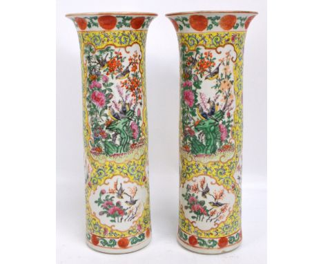 A pair of late 19th/early 20th century Chinese sleeve vases painted in enamels with various panels depicting birds amongst fo