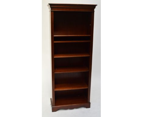 A reproduction mahogany tall bookcase with reeded sides, shaped plinth, and five shelves, width 74cm, height 193cm (one shelf