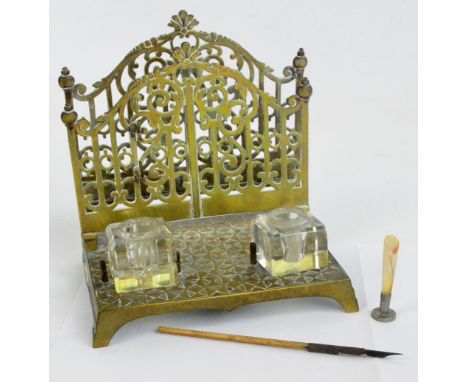 A brass desk tidy with pierced vertical letter holders and two glass square inkwells, one associated, width 19cm, a small mot