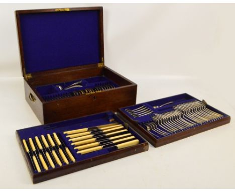 An oak canteen containing cutlery and flatware comprising twelve settings except teaspoons where there are only ten, plus six