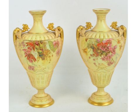 A pair of Royal Worcester blush ivory footed baluster vases, hand painted and gilt heightened with floral sprays, with gadroo