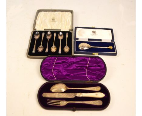 A cased Victorian christening set comprising knife, fork and spoon, all with bright cut decoration and monogram to the finial