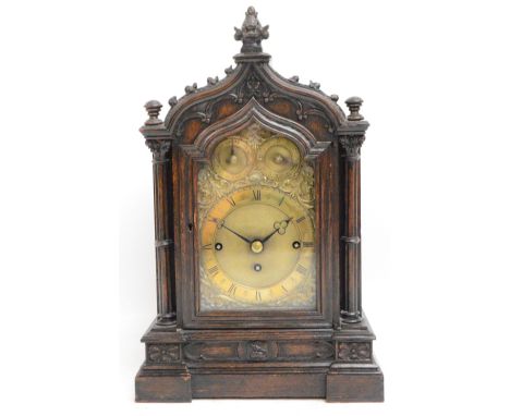 A late 19th century oak Gothic bracket clock, the shaped case set with a brass dial inscribed "Maple & Co Ltd, London", benea