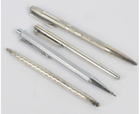 TIFFANY & CO; a sterling silver cased ballpoint pen with removable cover and geometric lozenge patterned body, stamped with T