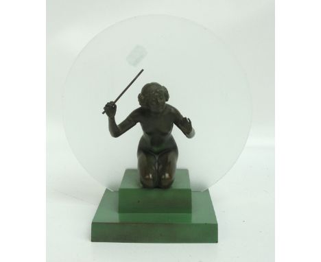 An Art Deco figural table lamp decorated with a spelter figure of a kneeling gymnast on square stepped base, with a frosted g
