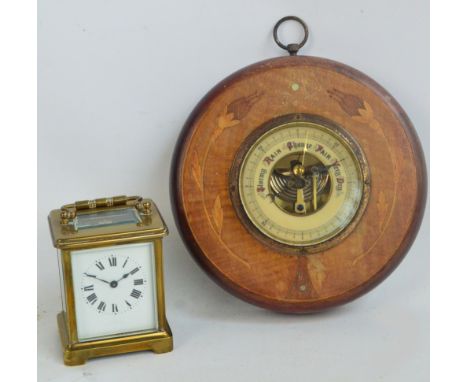 An early 20th century French brass carriage clock, the rectangular enamel dial set with circular chapter ring with Roman nume