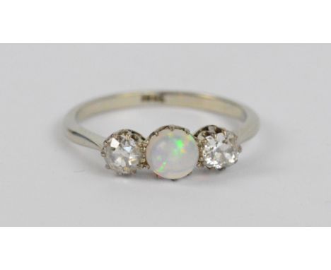 An 18ct white gold diamond and opal ring, the central circular opal flanked by two diamonds, size Q, approx 2.8g.