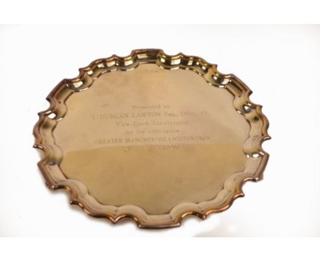 An Elizabeth II hallmarked silver salver of shaped circular form engraved with presentation inscription, Millennium mark for 