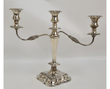 An Elizabeth II hallmarked silver two branch, three light candelabrum with detachable sconces, fluted scrolling branches, tap