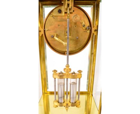 A late 19th century French brass cased four glass clock, the two-piece white enamel dial set with Roman numerals housing an e