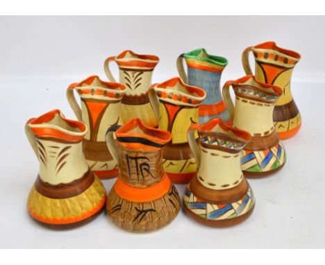 A collection of nine Myott, Son & Co ceramic Art Deco style geometrically hand printed jugs of tapering form, with loop handl