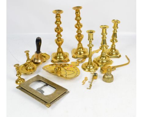 A small quantity of brass ware to include candlesticks, candle snuffer, opium pipe, a figural bell, etc.