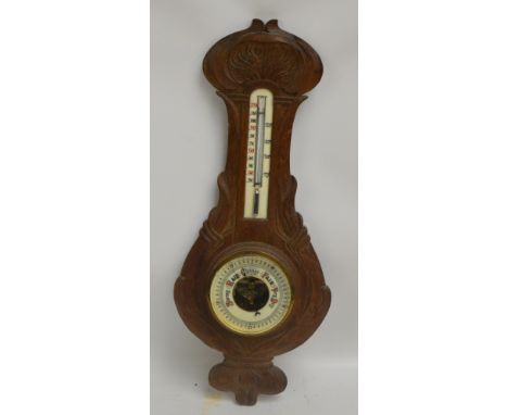 A carved oak Art Nouveau style banjo aneroid barometer/thermometer, height 56cm.