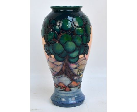 A modern Moorcroft "Mamoura" pattern tube line decorated baluster vase, impressed marks to base, dated with a candlestick for