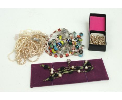 A collection of glass bead charms with silver mounts, a charm bracelet, other charms, a collection of simulated pearl necklac