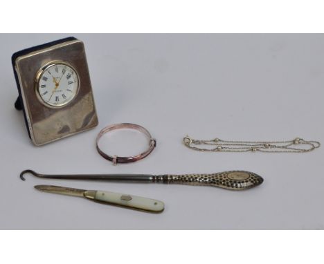 An Elizabeth II hallmarked silver faced small clock with circular dial set with Roman numerals and velvet easel back, Kitney 