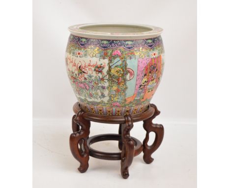 A 20th century Chinese porcelain fish bowl painted in enamels with panels depicting figural interior scenes and birds amongst