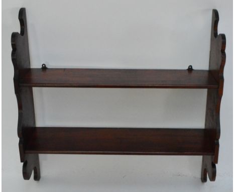 A late 19th century mahogany hanging wall shelf with shaped supports, width 76.5cm.