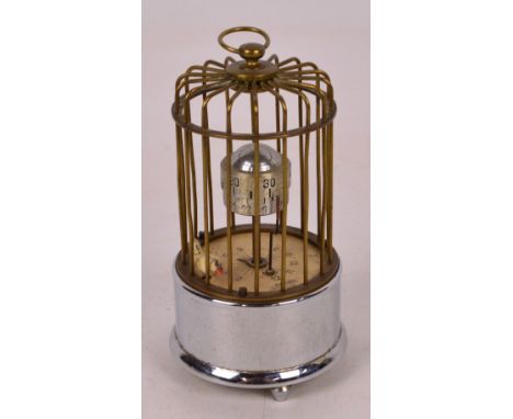 A novelty German birdcage automaton clock, inscribed "Kaiser Foreign" and raised on three turned supports, height 13cm. CONDI