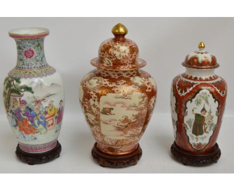 A Japanese Meiji period Satsuma jar and cover of baluster form, painted in enamels and gilt heightened with three panels depi