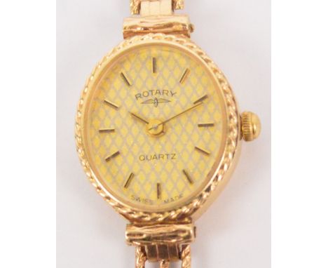 ROTARY; a 9ct yellow gold cased lady's wristwatch, the oval textured dial set with baton numerals and inscribed "Rotary Quart