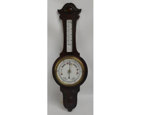 A 1930s carved oak banjo aneroid barometer/thermometer, height 84cm.