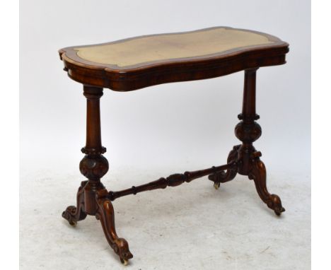 A Victorian rosewood card table, the shaped leather set top with swivel action and hinged leaf enclosing the playing surface 