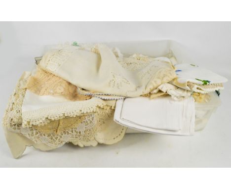 A quantity of 19th and 20th century textiles including lace, and lace edged doilies and table centres, other table linen incl