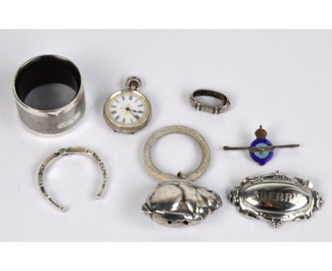 A small group of variously hallmarked silver items comprising a George V hallmarked silver napkin ring modelled as a horsesho