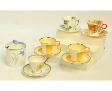 A group of five Shelley Art Deco style coffee cups and saucers to include a pair of "Regent" pattern and one "Eve" pattern ex