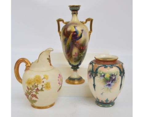 A Royal Worcester Hadley Ware twin handled urn shaped vase with circular base, decorated with two peacocks with green printed