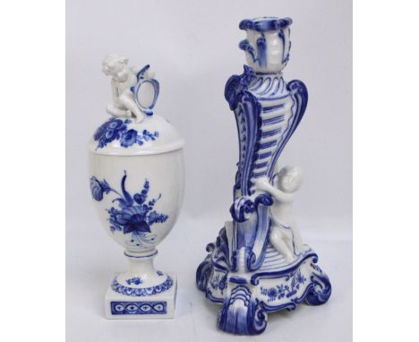A Royal Copenhagen porcelain urn overall painted with floral sprays, with malt finial modelled as a cherubic figure, raised o