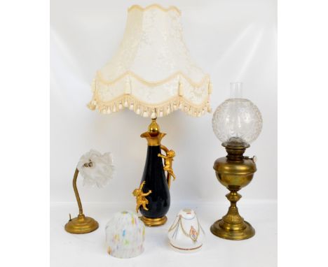 A Victorian brass oil lamp with globular floral etched decorated shade, a vintage table lamp with articulated stem with tulip