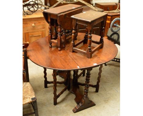 An oak dropleaf table with ring turned supports and bearing label inscribed "G.T. Rackstraw Ltd, Worcester" and two further s