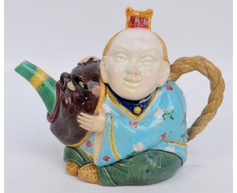 A late 19th century Mintons novelty teapot in the form of a Chinese figure with a mask, with impressed mark to base "Mintons 