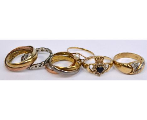 A collection of dress rings, comprising a 9ct yellow gold claddagh ring set with a central blue heart shaped stone, size O/P,