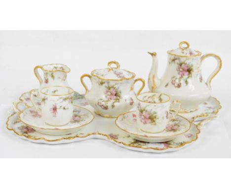 A Haviland & Co Limoges tea for two set, in "Feu de Four" pattern, comprising pot, jug, sucrier, two cups and saucers and a s